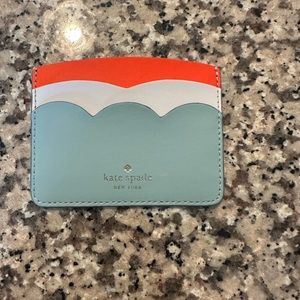 Tricolor Kate Spade card sleeve never used